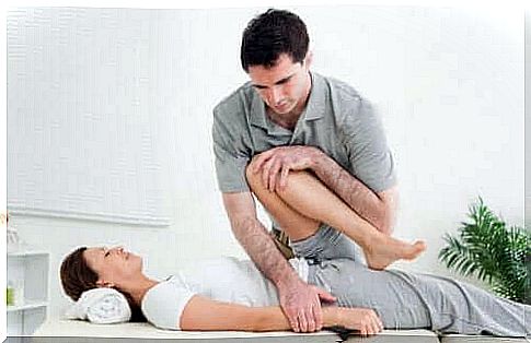 A woman performing rehab exercises with a physiotherapist
