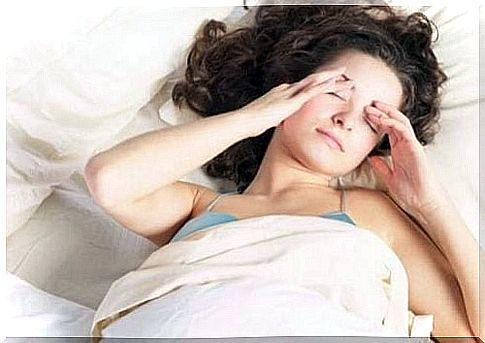 Woman waking up with a headache