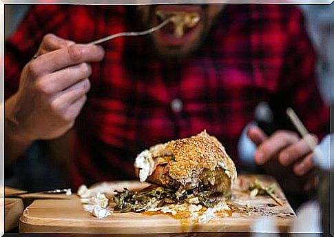 Man eating unhealthy meal