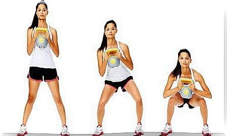 Woman doing squat with kettlebell