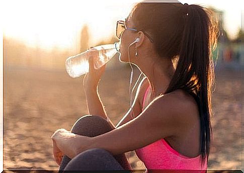 Woman drinking water outside