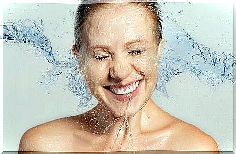 Woman smiling with water on face