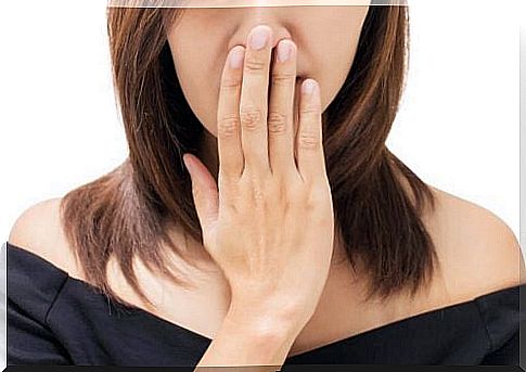 Woman holding her mouth shut