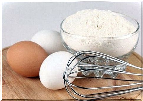 eggs, flour and whisk on cutting board