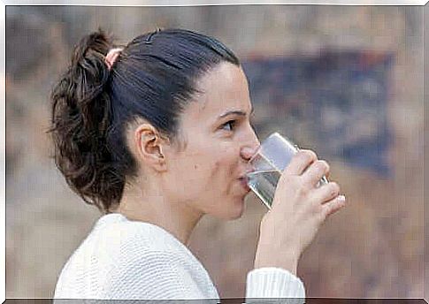 Woman drinking water and smiling