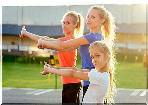 Woman and girl exercise using crossfit exercises for children