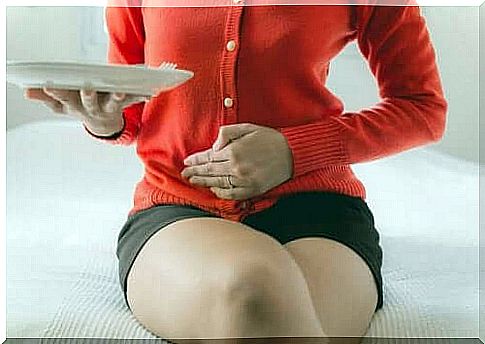 Woman with abdominal pain takes care of stomach