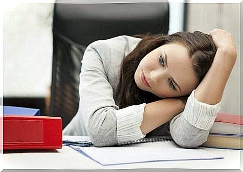 Depressed lady at table with notebook