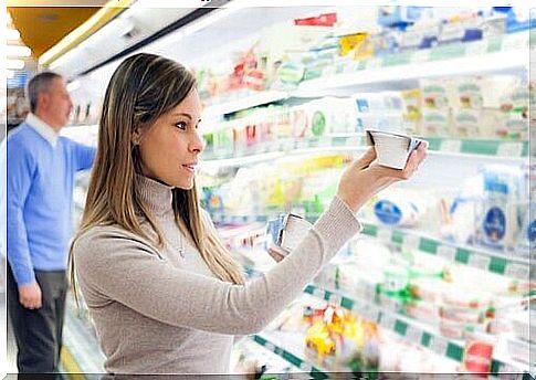 Woman looking at expiration date on foods