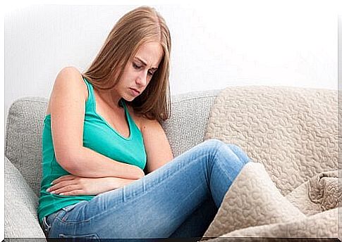 Woman with stomach problems on the couch