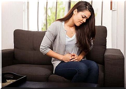 Woman with menstrual cramps takes care of stomach