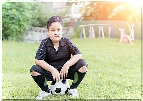 Boy sitting on football symbolizes good habits in children