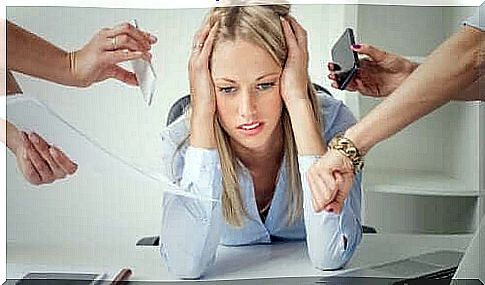 Woman with stress in office where everyone is pointing fingers