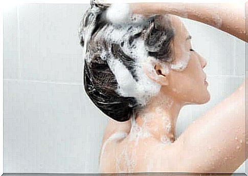 Woman is in the process of washing oily hair