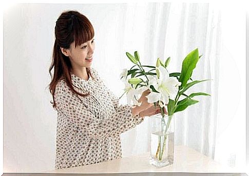 A woman arranges flower bouquets