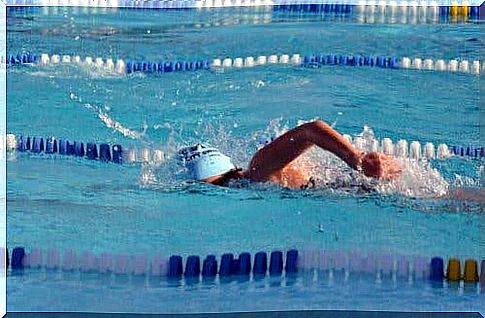 A woman is swimming in a pool