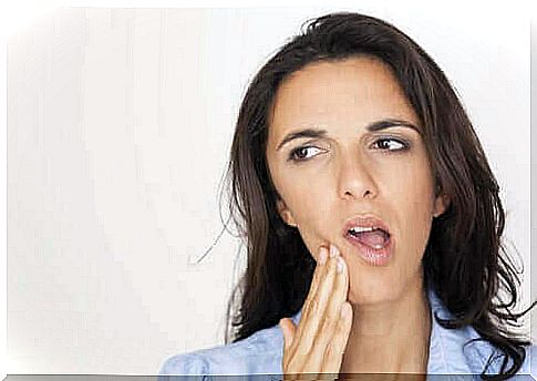 Woman with sensitive teeth takes care of mouth